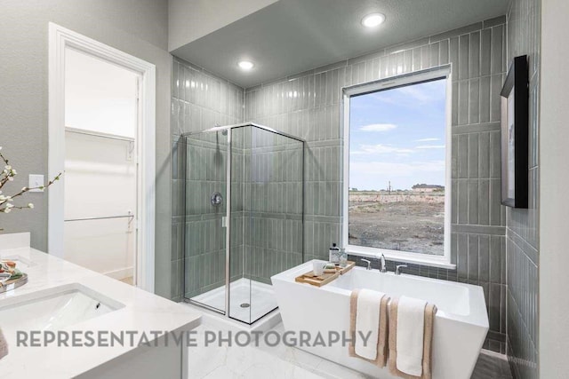 27019 Golden Isle Ln, Katy, TX 77493 - full bath with a soaking tub, a shower stall, vanity, a spacious closet, and recessed lighting