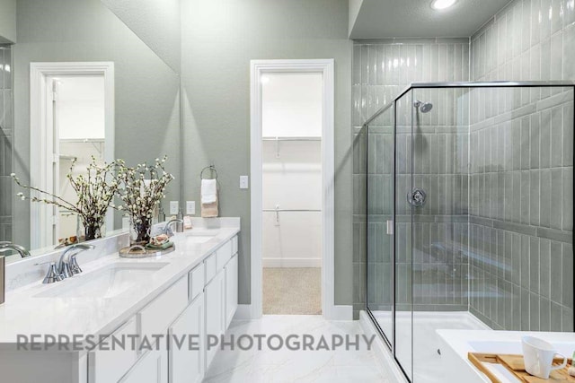 27019 Golden Isle Ln, Katy, TX 77493 - full bath with double vanity, a shower stall, a walk in closet, and baseboards