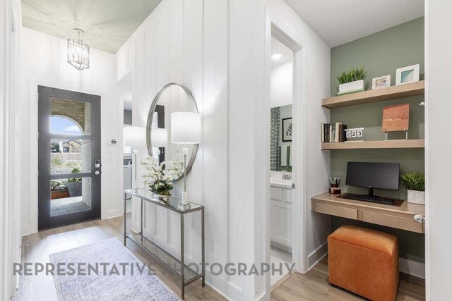 27019 Golden Isle Ln, Katy, TX 77493 - entrance foyer featuring built in study area, wood finished floors, and a chandelier