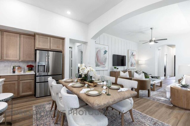 27019 Golden Isle Ln, Katy, TX 77493 - dining space featuring arched walkways, light wood-style flooring, and a ceiling fan