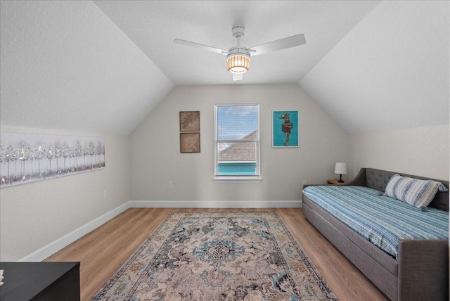 130 Beachcomber Ave, Surfside Beach, TX 77541 - bedroom featuring wood finished floors, vaulted ceiling, ceiling fan, and baseboards