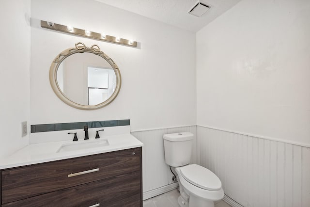 7202 Las Brisas Dr, Houston, TX 77083 - bathroom with vanity, a wainscoted wall, and toilet