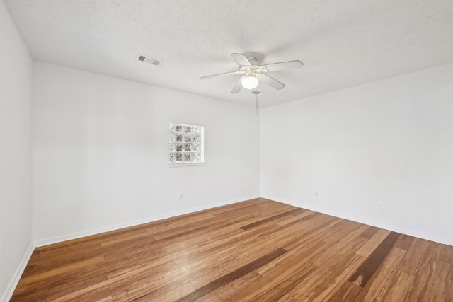 7202 Las Brisas Dr, Houston, TX 77083 - empty room featuring a ceiling fan, wood finished floors, a textured ceiling, and baseboards