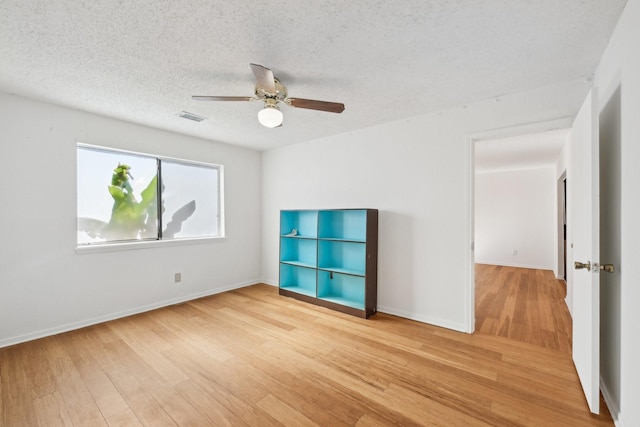 7202 Las Brisas Dr, Houston, TX 77083 - unfurnished room featuring a ceiling fan, light wood-style floors, baseboards, and a textured ceiling