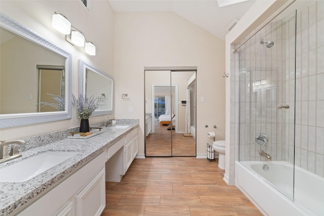 36 N Rain Forest Ct, Spring, TX 77380 - ensuite bathroom featuring toilet, double vanity, lofted ceiling, bathtub / shower combination, and wood finished floors