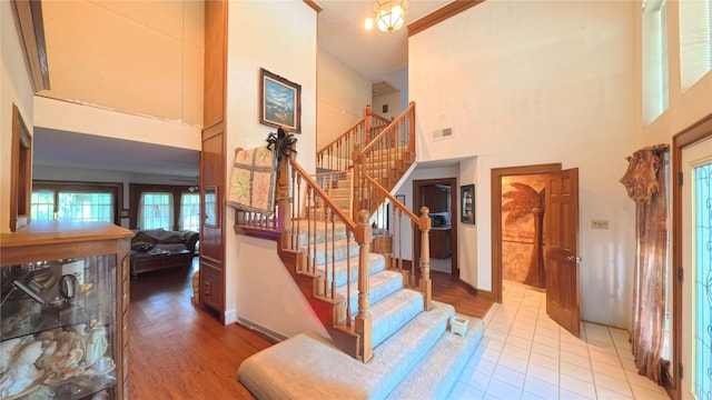 5707 Ancient Oaks Dr, Humble, TX 77346 - stairway with a high ceiling, baseboards, wood finished floors, and a ceiling fan