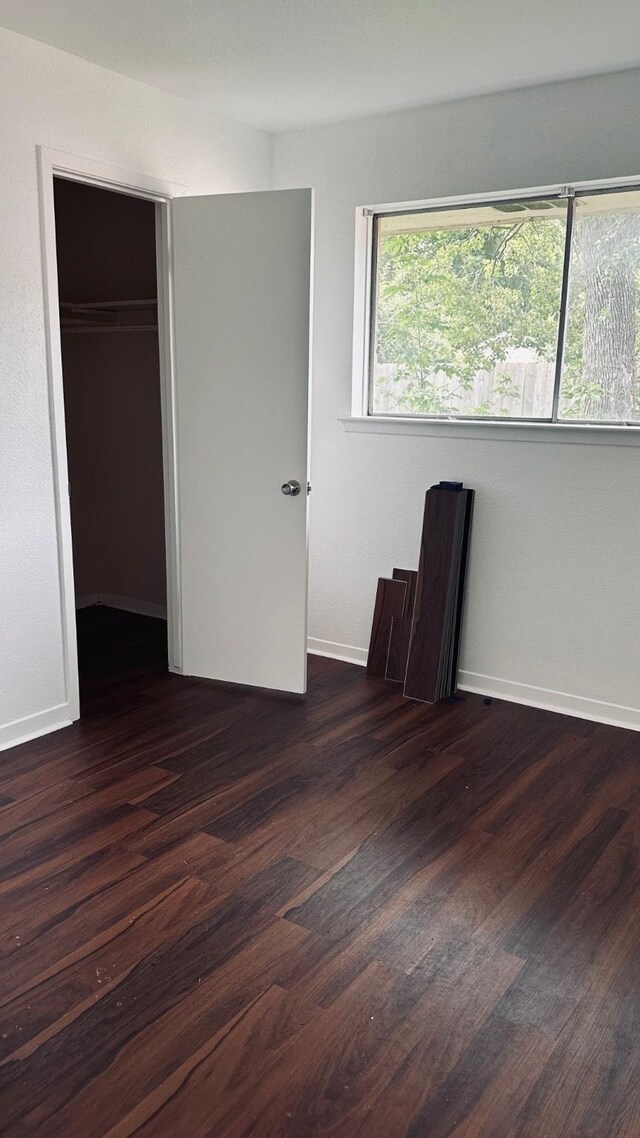 10126 Pine Moss Dr, Houston, TX 77040 - unfurnished bedroom featuring wood finished floors, baseboards, and a closet