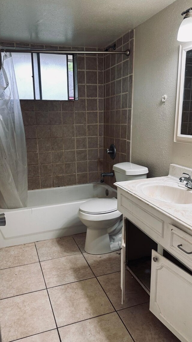 10126 Pine Moss Dr, Houston, TX 77040 - bathroom with vanity, shower / bath combo with shower curtain, toilet, tile patterned flooring, and a textured wall