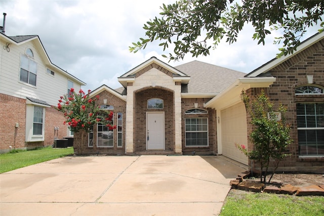 22922 Still Pond Dr, Tomball, TX 77375 - french provincial home with brick siding, driveway, an attached garage, and a shingled roof