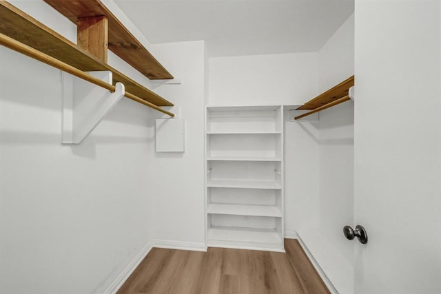 9039 Sandstone St, Houston, TX 77036 - walk in closet featuring wood finished floors