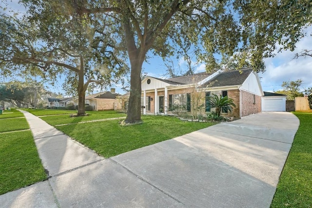 9039 Sandstone St, Houston, TX 77036 - view of front of home featuring brick siding, a front lawn, and concrete driveway