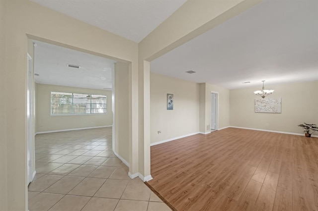 9039 Sandstone St, Houston, TX 77036 - empty room with a chandelier and baseboards