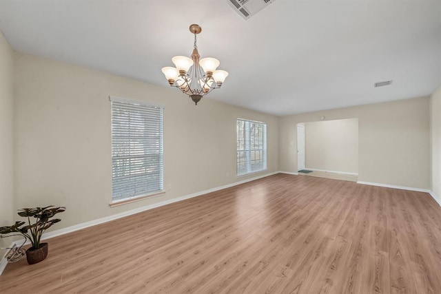 9039 Sandstone St, Houston, TX 77036 - spare room with light wood-style floors, a chandelier, and baseboards
