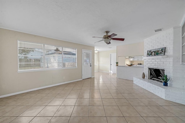 9039 Sandstone St, Houston, TX 77036 - unfurnished living room featuring ceiling fan, a fireplace, light tile patterned flooring, and baseboards