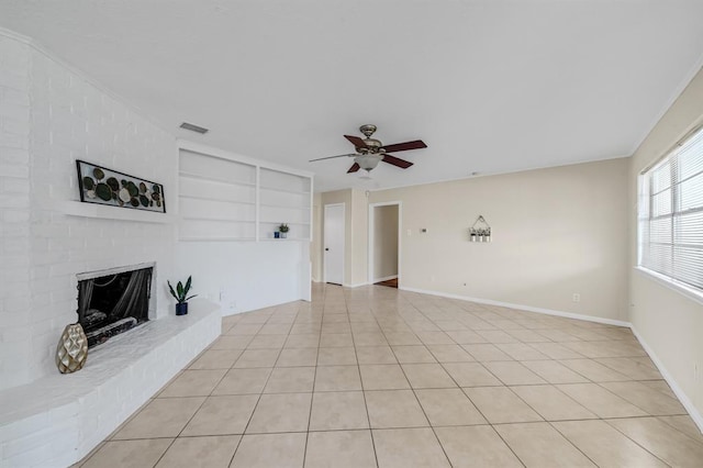 9039 Sandstone St, Houston, TX 77036 - unfurnished living room featuring ceiling fan, built in shelves, a fireplace, baseboards, and light tile patterned flooring