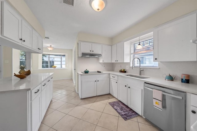 9039 Sandstone St, Houston, TX 77036 - kitchen with stainless steel dishwasher, a sink, under cabinet range hood, black electric stovetop, and white cabinetry