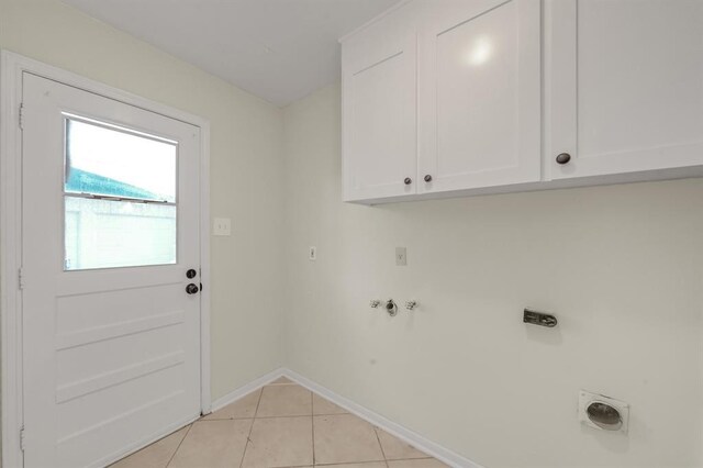 9039 Sandstone St, Houston, TX 77036 - laundry room with hookup for an electric dryer, cabinet space, baseboards, light tile patterned floors, and washer hookup