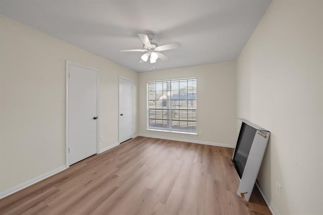 9039 Sandstone St, Houston, TX 77036 - unfurnished bedroom featuring light wood-type flooring, baseboards, and a ceiling fan
