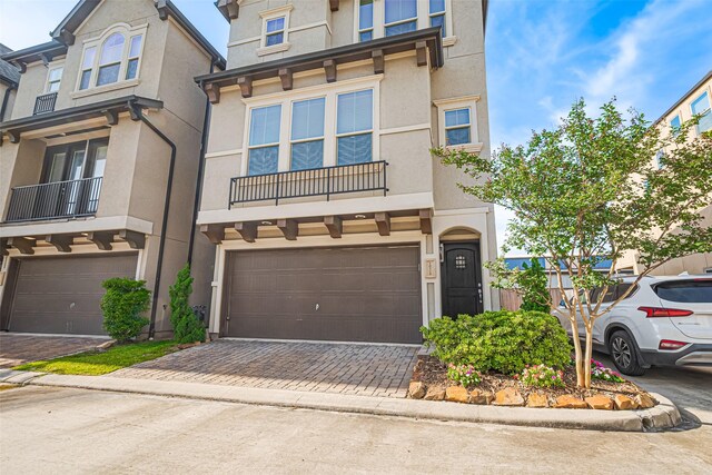 10712 Addicks Oaks Pl, Houston, TX 77043 - multi unit property featuring a garage, stucco siding, and decorative driveway
