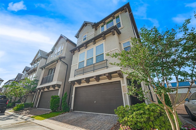 10712 Addicks Oaks Pl, Houston, TX 77043 - multi unit property featuring a garage, stucco siding, and decorative driveway