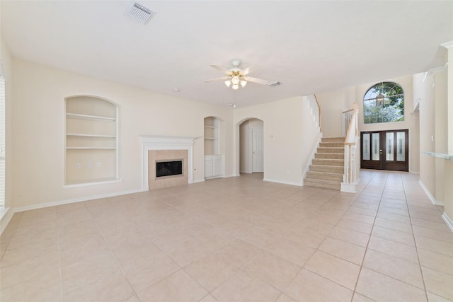 12236 S Shadow Cove Dr, Houston, TX 77082 - unfurnished living room with built in features, light tile patterned floors, stairs, and a premium fireplace