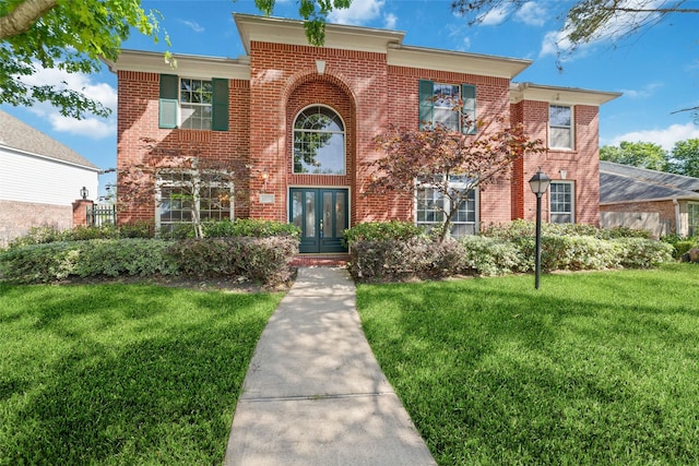 12236 S Shadow Cove Dr, Houston, TX 77082 - view of front of house with a front yard, brick siding, and french doors
