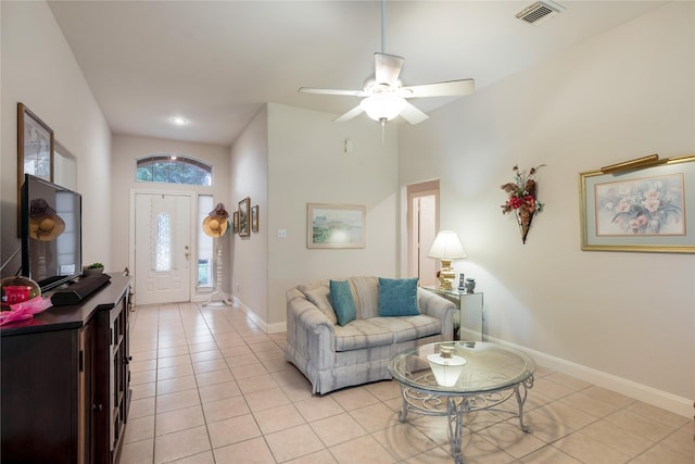1511 Ashley Ct, Tomball, TX 77375 - living room with light tile patterned flooring, baseboards, ceiling fan, and a high ceiling