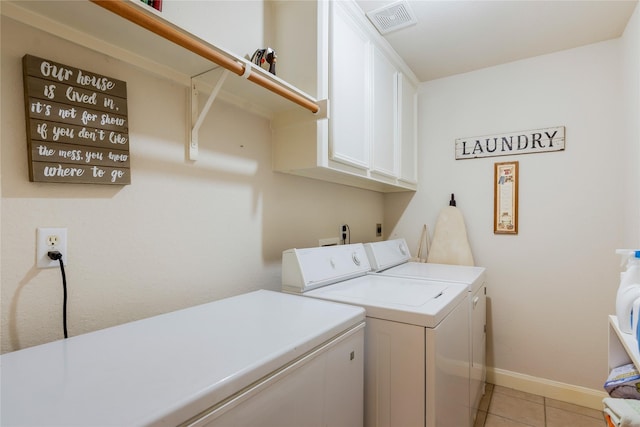 1511 Ashley Ct, Tomball, TX 77375 - washroom with cabinet space, washing machine and clothes dryer, baseboards, and light tile patterned floors
