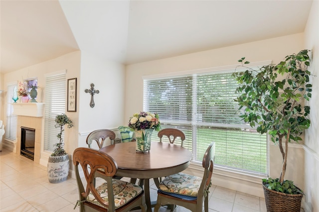 1511 Ashley Ct, Tomball, TX 77375 - dining space with light tile patterned floors, a tiled fireplace, and vaulted ceiling