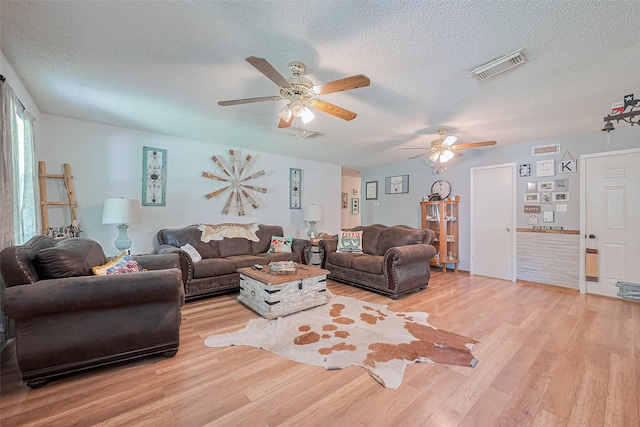 200 Little Pine Valley Rd, Cleveland, TX 77328 - living area with light wood-type flooring, ceiling fan, and a textured ceiling