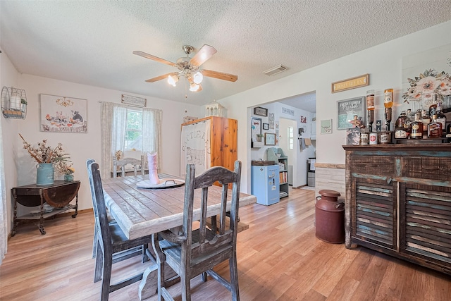 200 Little Pine Valley Rd, Cleveland, TX 77328 - dining area with ceiling fan, a textured ceiling, and light wood-type flooring