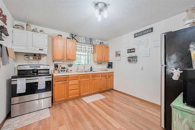 200 Little Pine Valley Rd, Cleveland, TX 77328 - kitchen featuring appliances with stainless steel finishes, a textured ceiling, under cabinet range hood, light countertops, and light wood-style floors