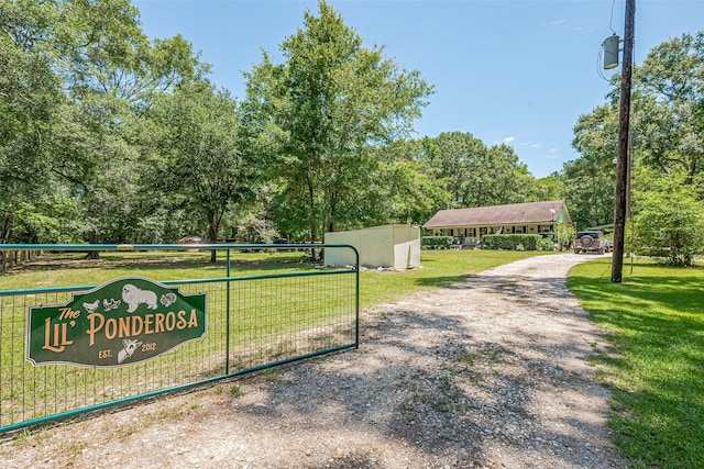 200 Little Pine Valley Rd, Cleveland, TX 77328 - view of property's community with a lawn and view of scattered trees