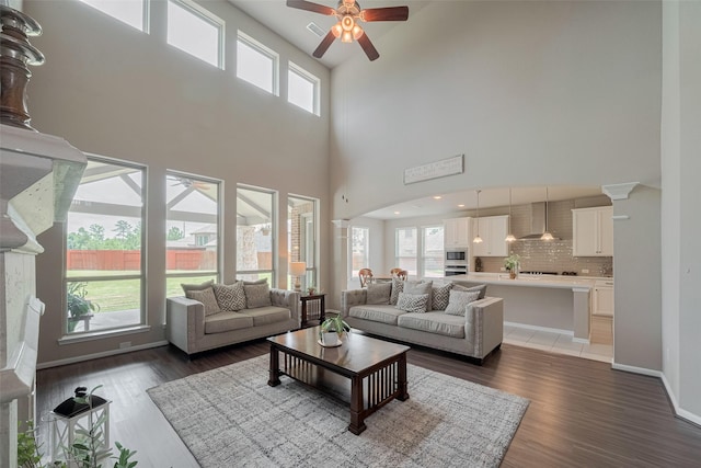 25203 Azel Shore Ct, Porter, TX 77365 - living area with a ceiling fan, a high ceiling, light wood finished floors, and arched walkways