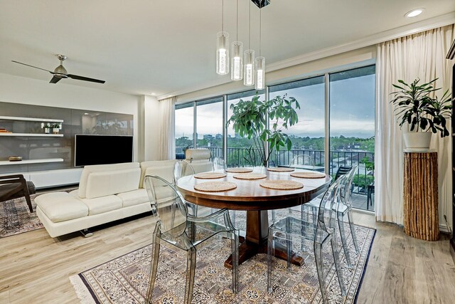 2200 Willowick Rd Unit 4E, Houston, TX 77027 - dining room with wood finished floors, ceiling fan, recessed lighting, and crown molding