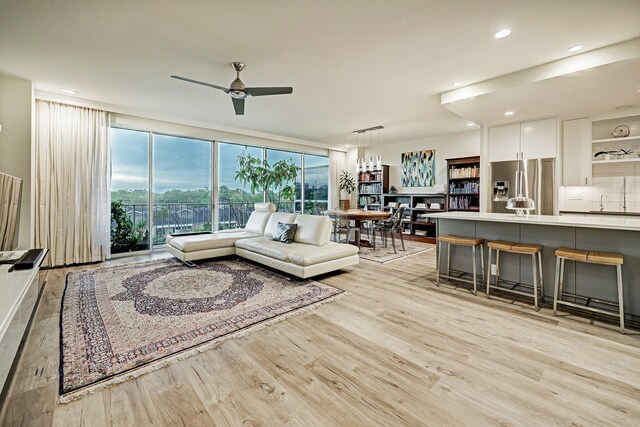 2200 Willowick Rd Unit 4E, Houston, TX 77027 - living room featuring light wood finished floors, a ceiling fan, and recessed lighting