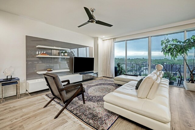 2200 Willowick Rd Unit 4E, Houston, TX 77027 - living area featuring a ceiling fan, plenty of natural light, and light wood finished floors