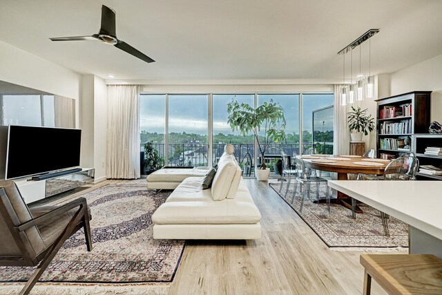 2200 Willowick Rd Unit 4E, Houston, TX 77027 - living room with wood finished floors, plenty of natural light, and a ceiling fan