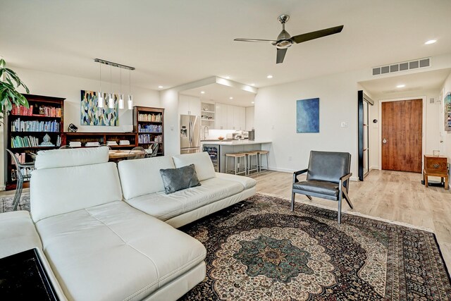 2200 Willowick Rd Unit 4E, Houston, TX 77027 - living room with a ceiling fan, light wood-style flooring, beverage cooler, and recessed lighting