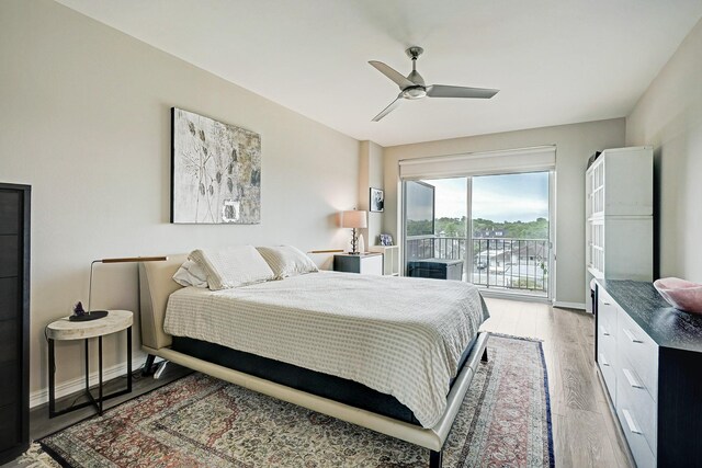 2200 Willowick Rd Unit 4E, Houston, TX 77027 - bedroom with access to exterior, baseboards, light wood-style floors, and a ceiling fan