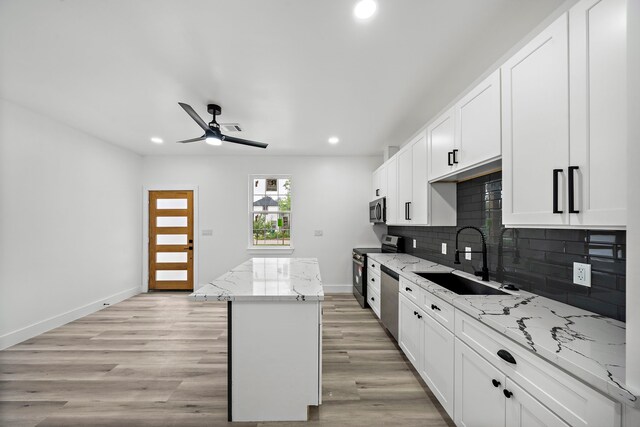 8209 Richland St A/B, Unit A/B Houston, TX 77028 - kitchen featuring a sink, appliances with stainless steel finishes, a center island, recessed lighting, and a ceiling fan