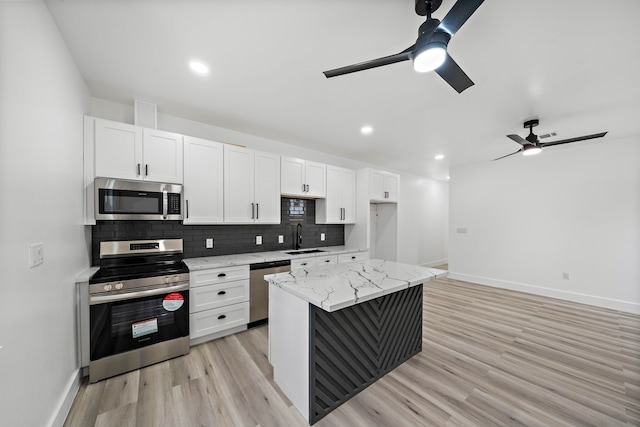 8209 Richland St A/B, Unit A/B Houston, TX 77028 - kitchen featuring stainless steel appliances, a ceiling fan, baseboards, light wood-type flooring, and a sink