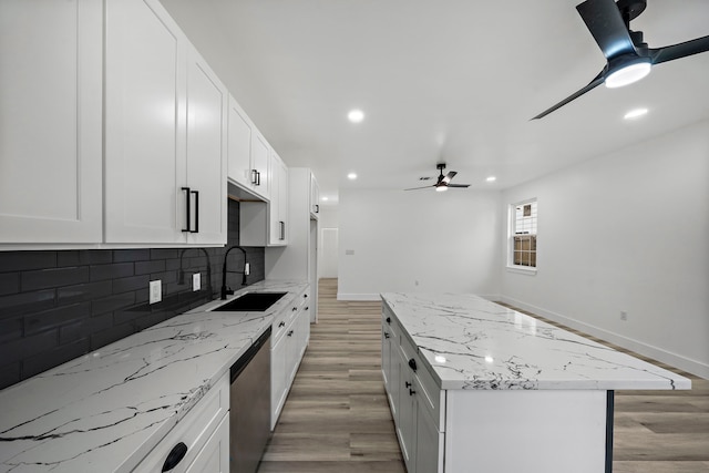 8209 Richland St A/B, Unit A/B Houston, TX 77028 - kitchen with a sink, stainless steel dishwasher, light wood-style flooring, ceiling fan, and tasteful backsplash