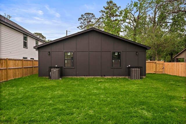 8209 Richland St A/B, Unit A/B Houston, TX 77028 - rear view of house with central AC and a gate