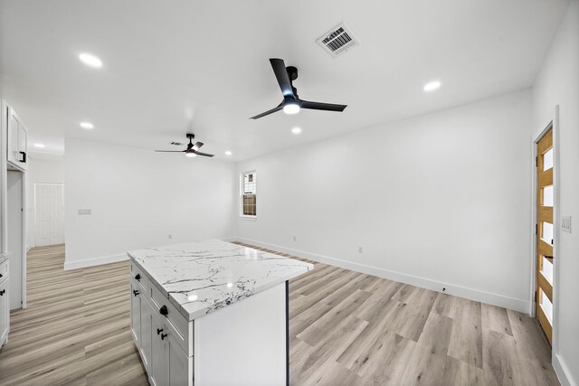 8209 Richland St A/B, Unit A/B Houston, TX 77028 - kitchen featuring ceiling fan, recessed lighting, a kitchen island, light wood-style floors, and white cabinets