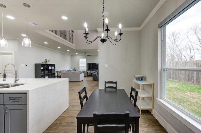 14514 Sanour Dr, Houston, TX 77084 - dining room with a ceiling fan, ornamental molding, dark wood-type flooring, recessed lighting, and a chandelier