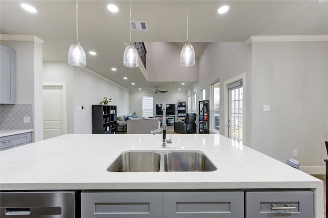 14514 Sanour Dr, Houston, TX 77084 - kitchen with gray cabinets, a sink, open floor plan, recessed lighting, and crown molding