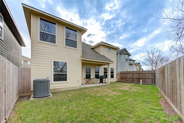 14514 Sanour Dr, Houston, TX 77084 - rear view of property featuring central AC unit, a patio area, and roof with shingles