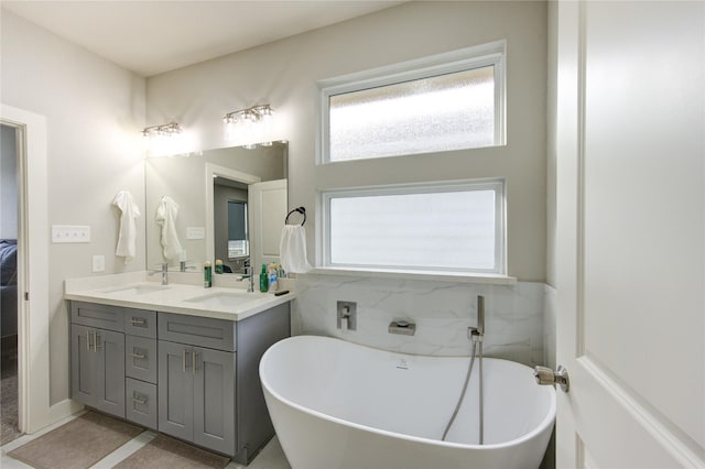 14514 Sanour Dr, Houston, TX 77084 - bathroom with a freestanding tub and double vanity