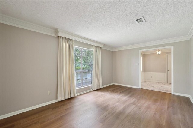 5210 Linda Ln, Beaumont, TX 77708 - spare room with wood finished floors, a textured ceiling, and ornamental molding
